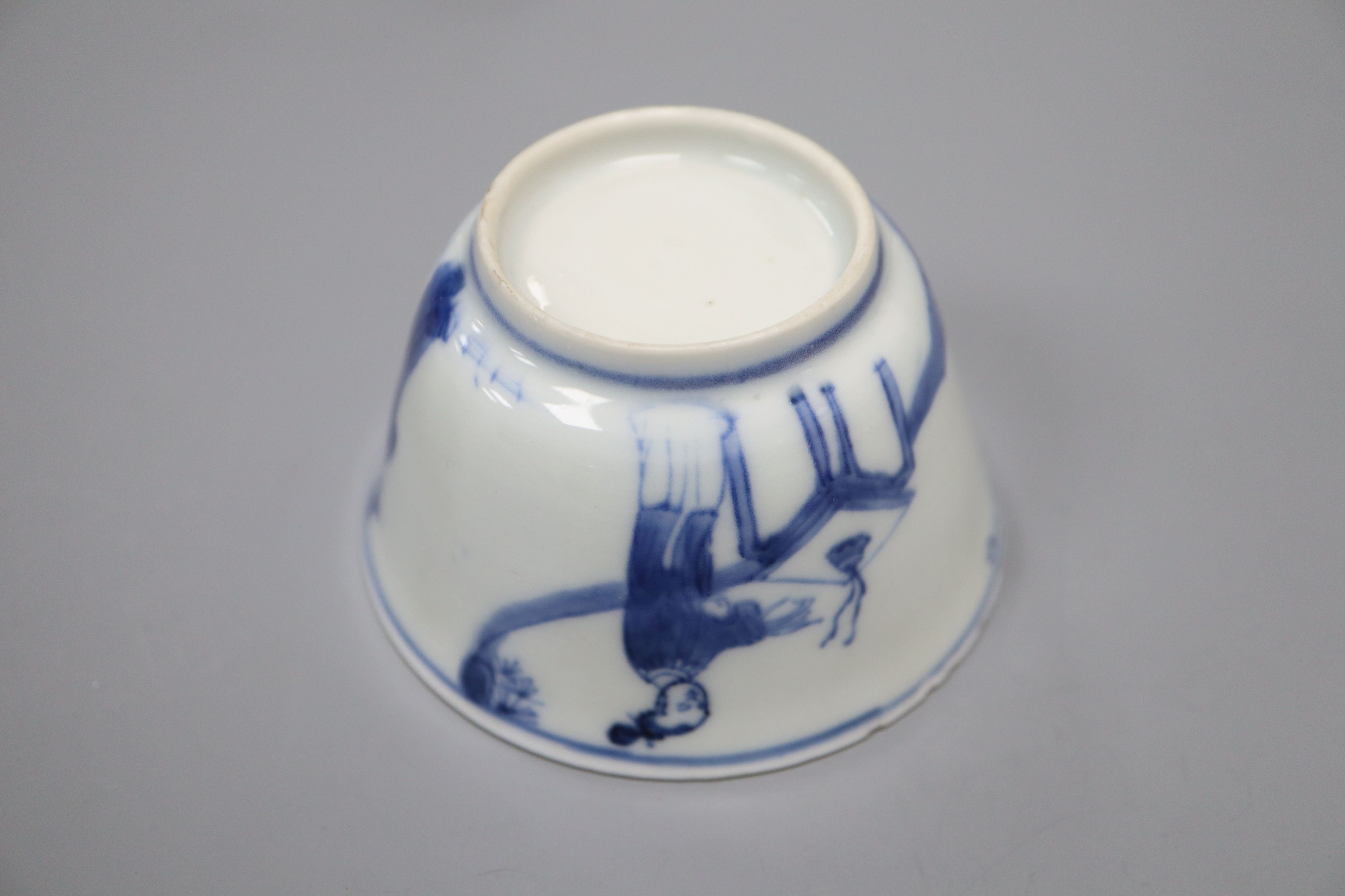A Chinese Kangxi blue and white saucer dish and a similar tea bowl and saucer